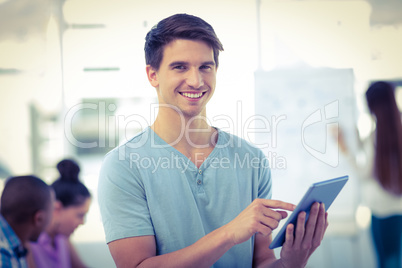 Young creative worker using tablet