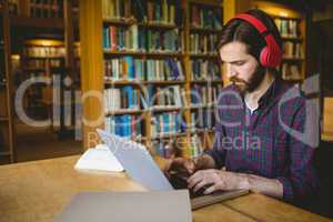 Hipster student studying in library