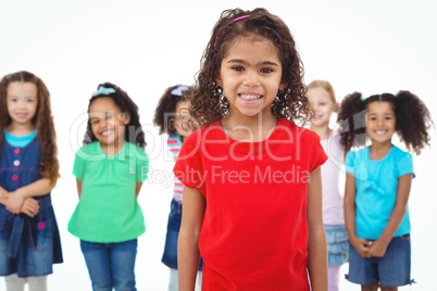 Kids standing together with girl in front