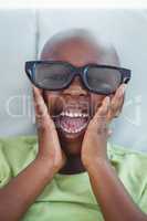 Close up of a boy wearing 3d glasses for a moive