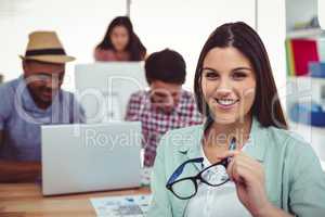 Young creative worker smiling at camera