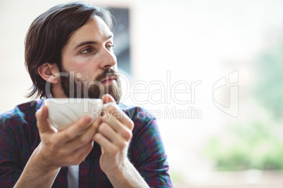 Hipster student having coffee in canteen