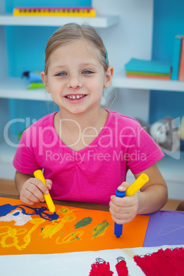 Children drawing on coloured paper