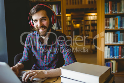 Hipster student studying in library