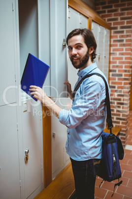 Hipster student smiling at camera in hallway