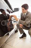 Focused businessman looking at the car body