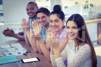 Creative business team at meeting applauding