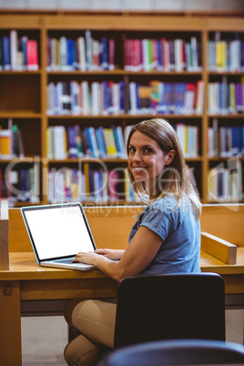 Mature student in the library using laptop