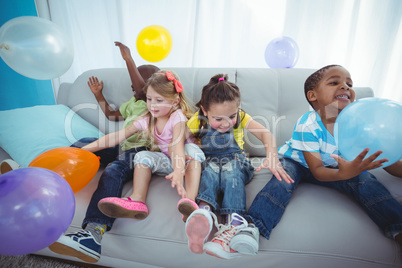 Smiling kids playing with balloons