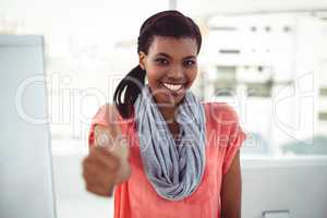 Smiling creative businesswoman by her desk