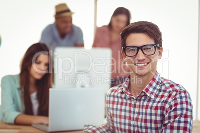 Young creative worker smiling at camera