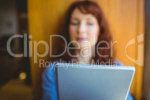 Mature student using tablet in cafe