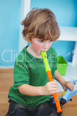 Small boy playing the flute