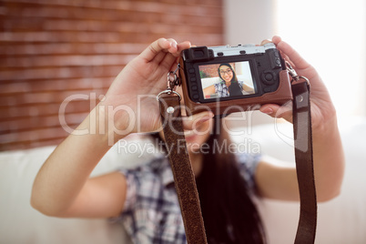 Asian woman on the couch taking selfie