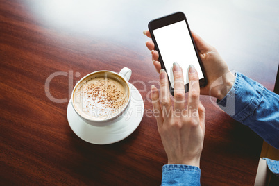 Woman taking a photo of her coffee