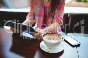 Mature student using tablet in cafe