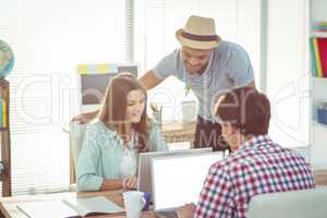 Creative team working together at desk