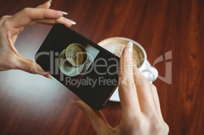 Woman taking a photo of her coffee