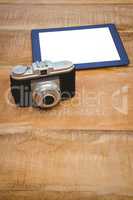 View of an old camera and a blue tablet