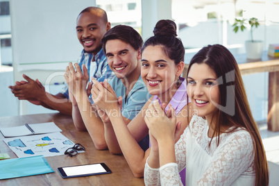 Creative business team at meeting applauding