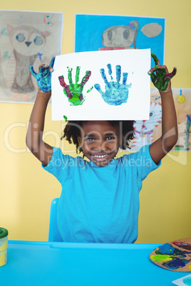 Smiling kid holding up his hands