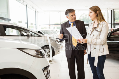 Salesman showing a car to a client