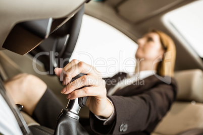 Smiling businesswoman siting in a car