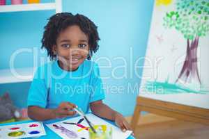 Happy kid enjoying arts and crafts painting