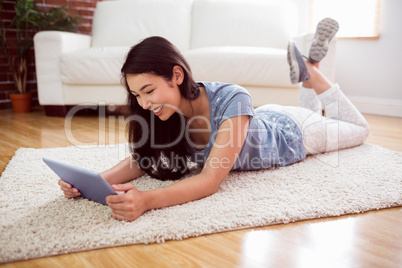 Asian woman using tablet on floor Asian woman using tablet on floor