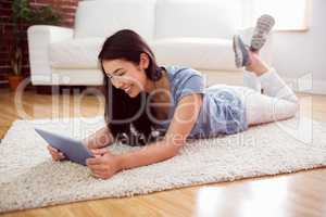 Asian woman using tablet on floor