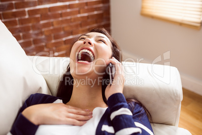 Asian woman laughing on the phone