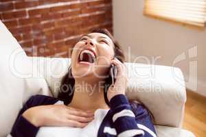 Asian woman laughing on the phone