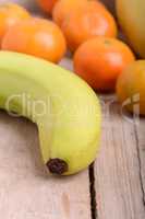 Fresh colorful fruits composition mandarin, bananas and orange