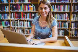 Mature student in the library using laptop