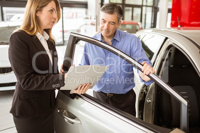 Focused businessman undersign a car contract