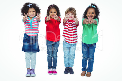 Smiling kids holding up fingers making peace signs