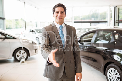 Smiling salesman ready to shake hand