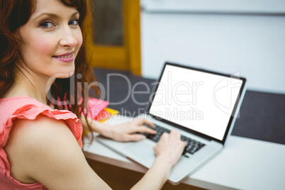 Mature student in lecture hall using laptop Mature student in lecture hall using laptop