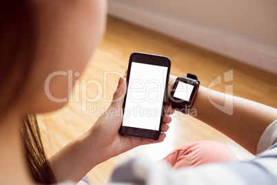 Asian woman using smart watch and phone