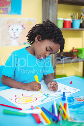 Happy kid drawing on his sheet