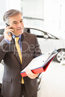 Smiling salesman having a phone call