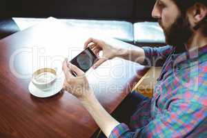 Hipster student taking photo of coffee