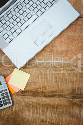 Business desk with laptop and calculator