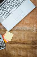 Business desk with laptop and calculator