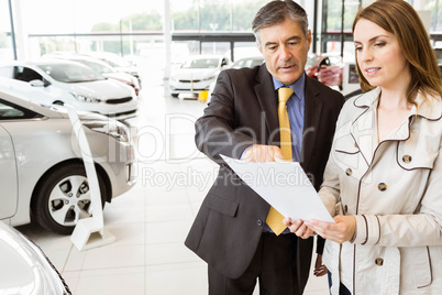 Salesman explaining the contract to a client