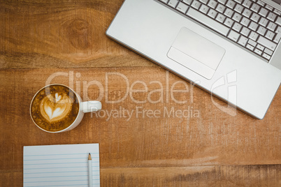 Above view of a laptop and a coffee