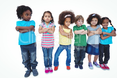 A row of children standing together with crossed arms