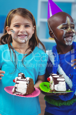 Happy kids eating birthday cake