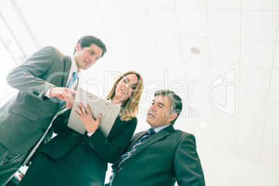 Sales team look at a clipboard