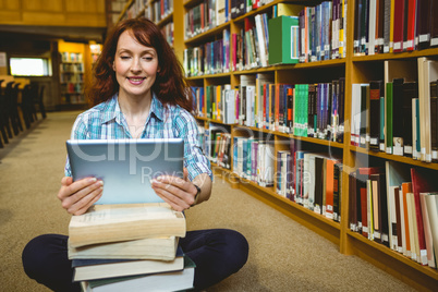 Mature student in library using tablet